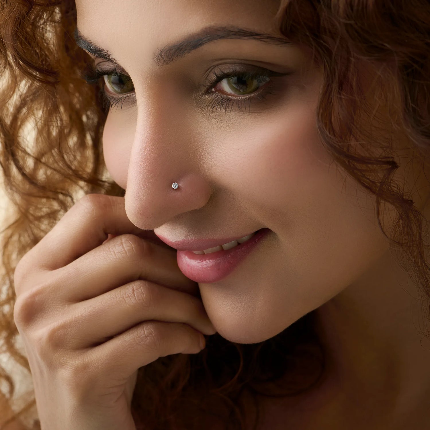 Woman wearing elegant Kerala style gold diamond nose pin close-up portrait