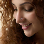 Woman wearing trendy gold nose pin close-up portrait