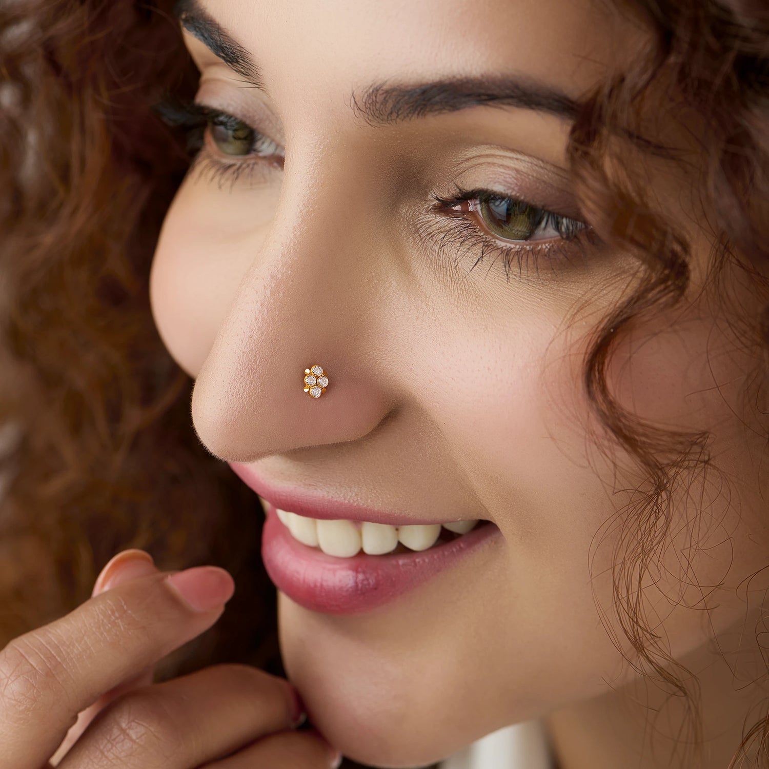 Woman wearing women's gold nose pin design with minimal floral diamond look