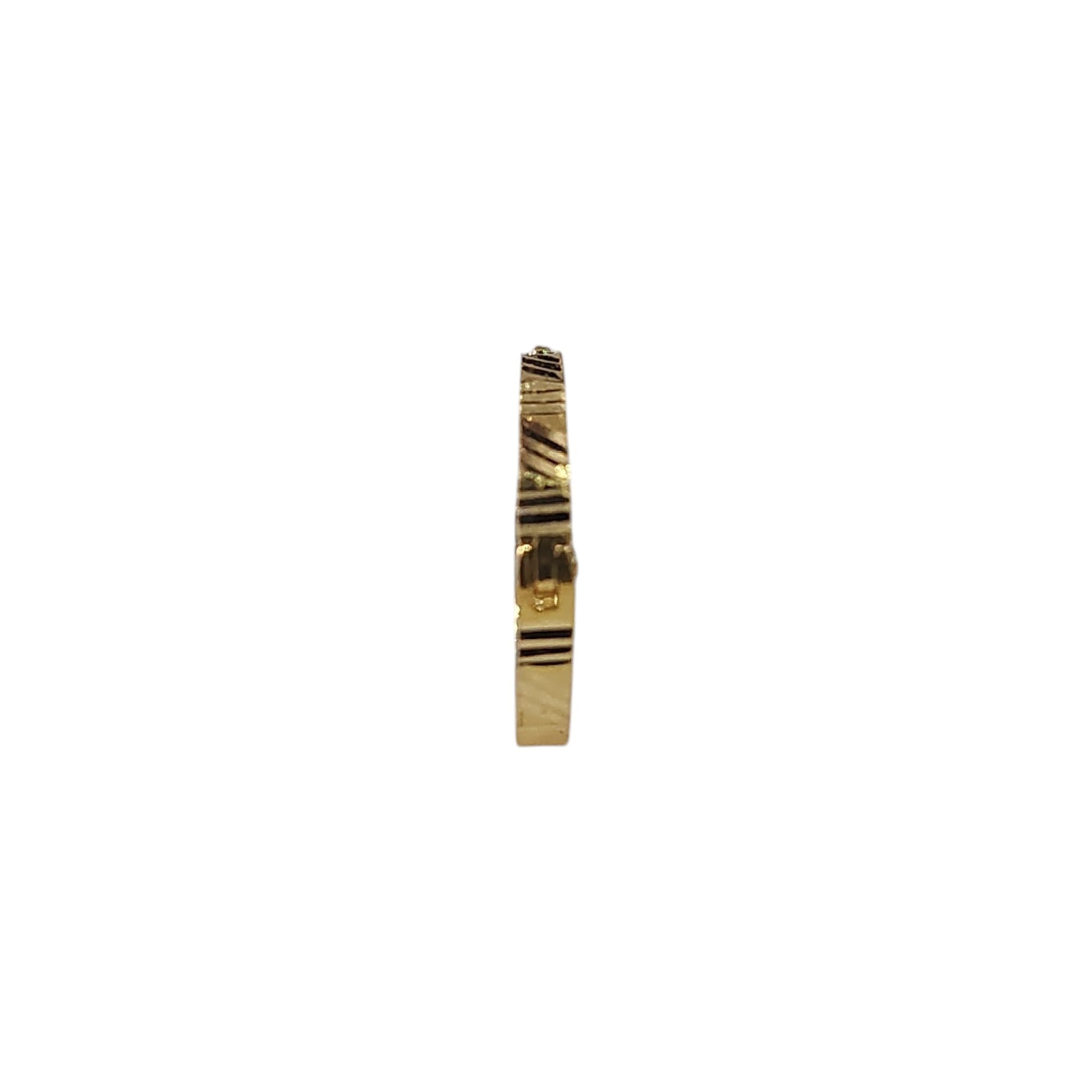 Side profile view of slim 18K gold nose ring on a white surface showing its narrow band design